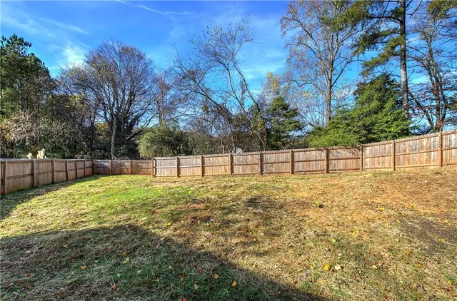 a view of a backyard with large trees