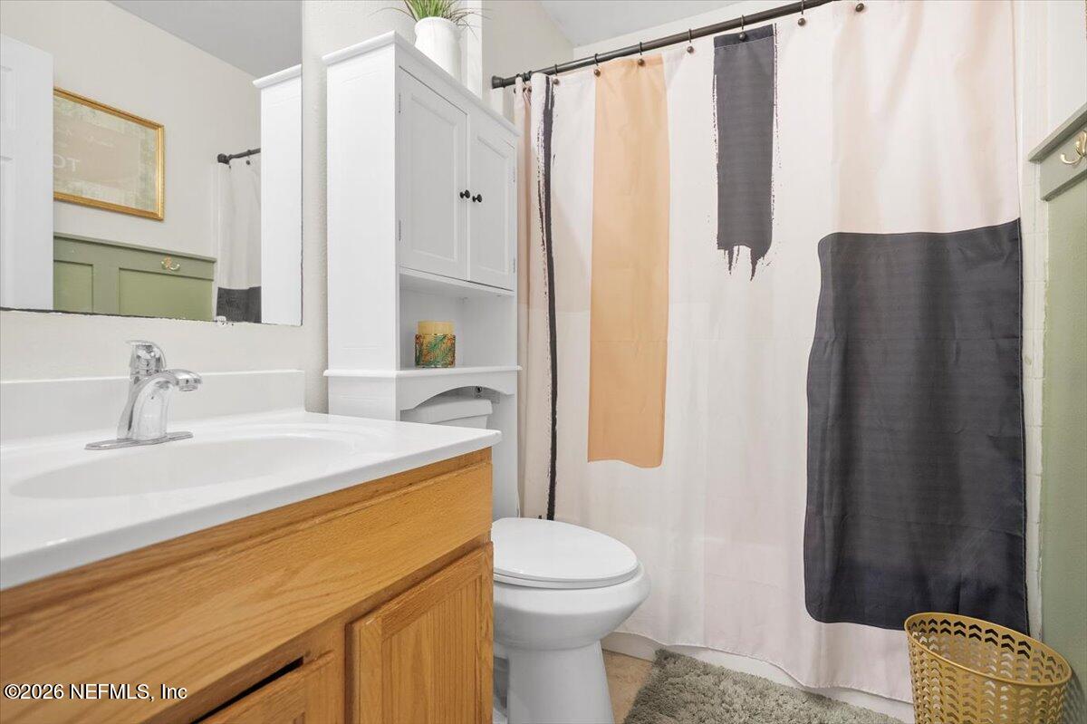 10310 Woodley Point Road Jacksonville, FL 32218 - Photo 10 of 30 a bathroom with a sink toilet and shower