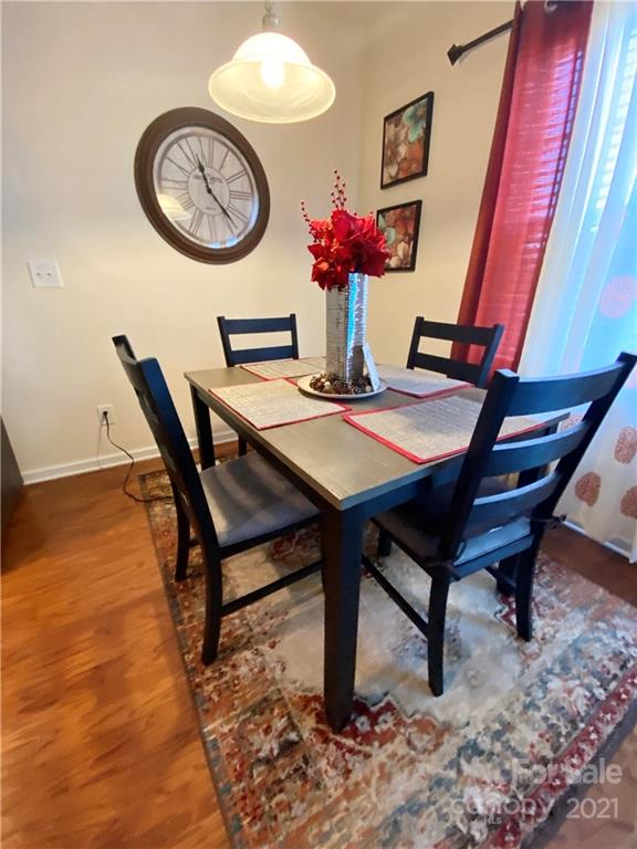 6339 Prosperity Church Road Charlotte, NC 28269 - Photo 11 of 21 a view of a dining room with furniture and chandelier