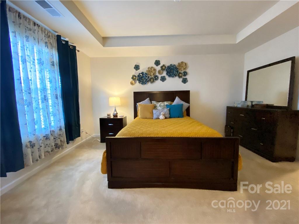 6339 Prosperity Church Road Charlotte, NC 28269 - Photo 15 of 21 a bed sitting in a bedroom next to a window