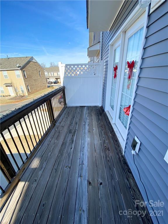 6339 Prosperity Church Road Charlotte, NC 28269 - Photo 20 of 21 a view of a balcony with wooden floor