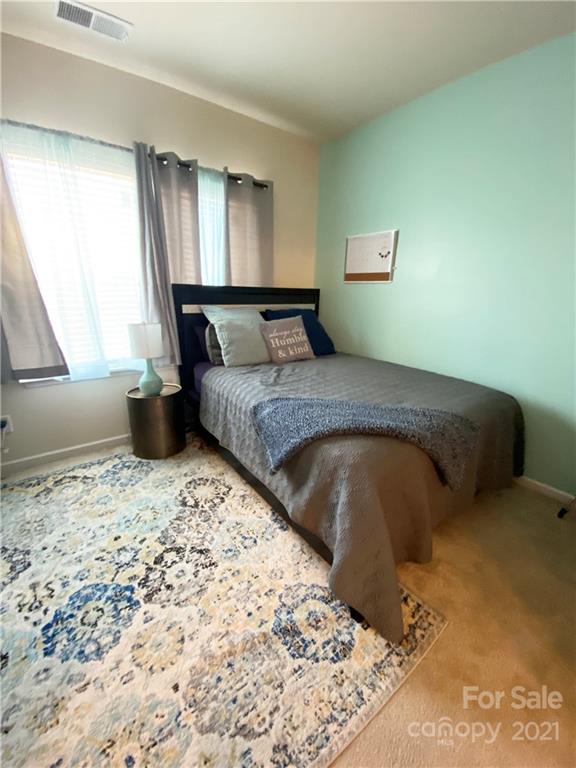 6339 Prosperity Church Road Charlotte, NC 28269 - Photo 5 of 21 a bed sitting in a bedroom next to a window