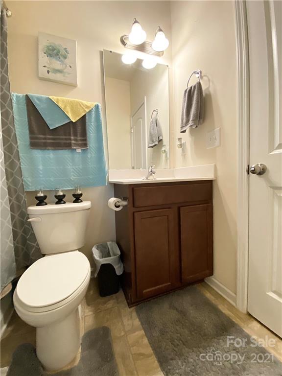 6339 Prosperity Church Road Charlotte, NC 28269 - Photo 6 of 21 a bathroom with a toilet a sink and mirror