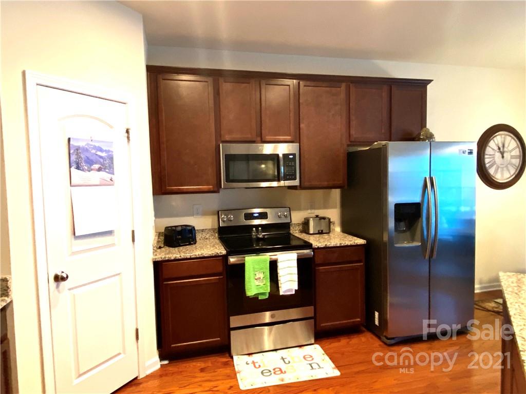 6339 Prosperity Church Road Charlotte, NC 28269 - Photo 8 of 21 a kitchen with stainless steel appliances granite countertop a refrigerator stove and microwave