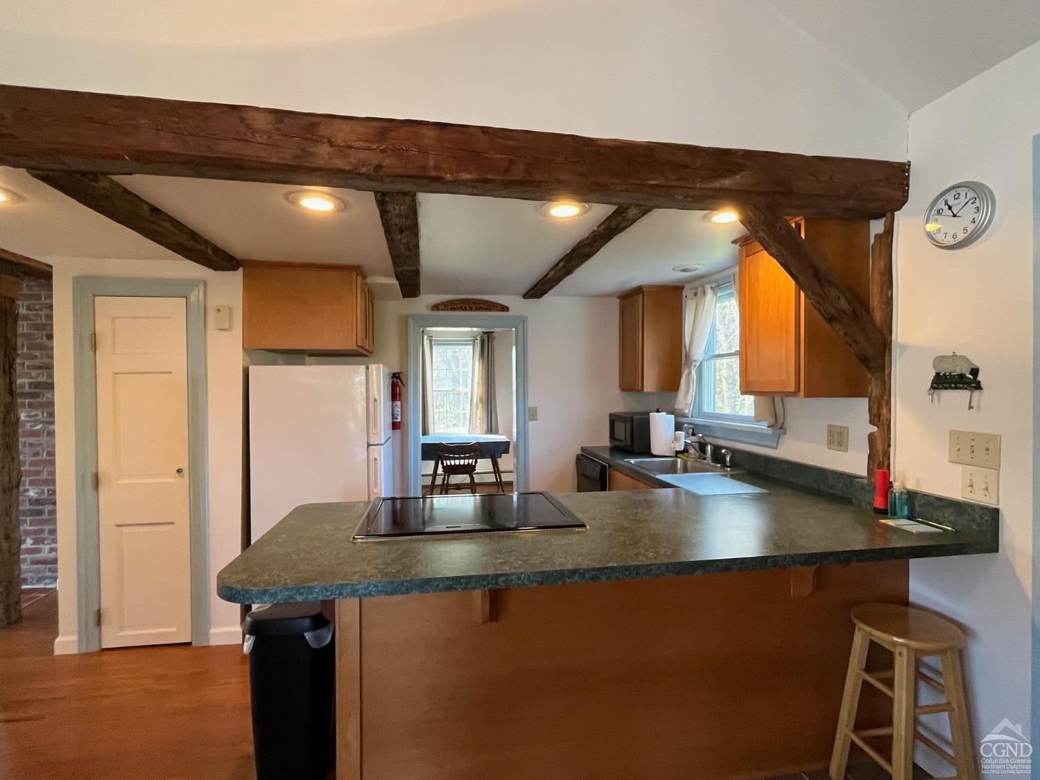 39 Haight Road Amenia, NY 12501 - Photo 5 of 11 a kitchen with sink a refrigerator and chairs