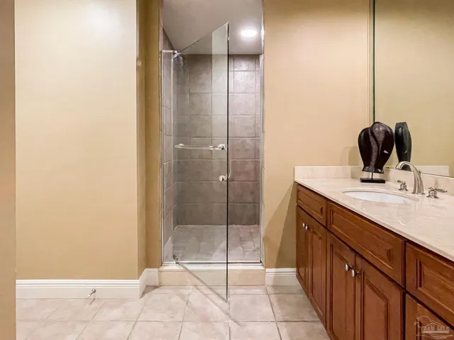 a bathroom with a mirror a sink and shower