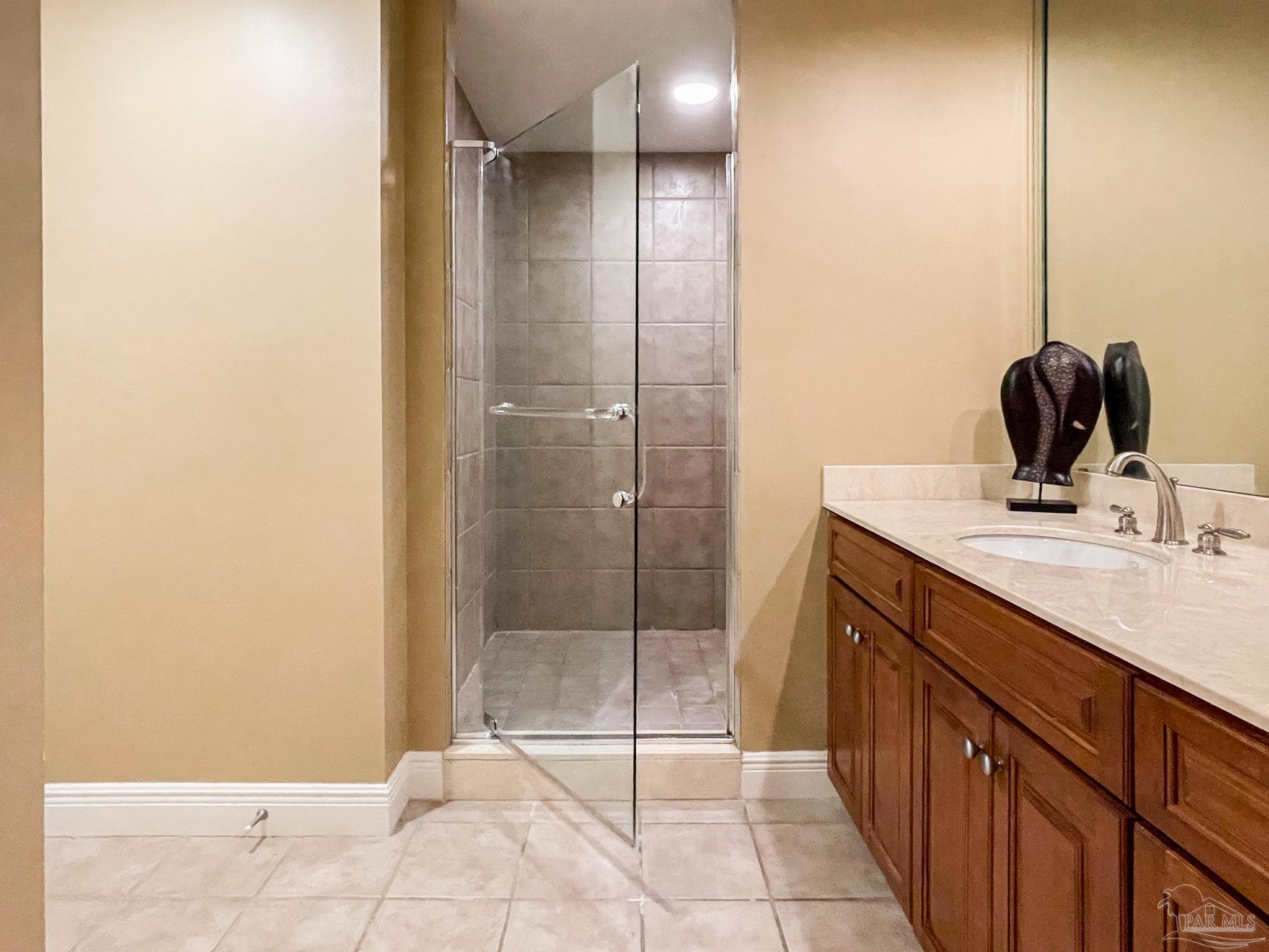 608 Lost Key Drive, Unit 604C Perdido Key, FL 32507 - Photo 14 of 38 a bathroom with a mirror a sink and shower