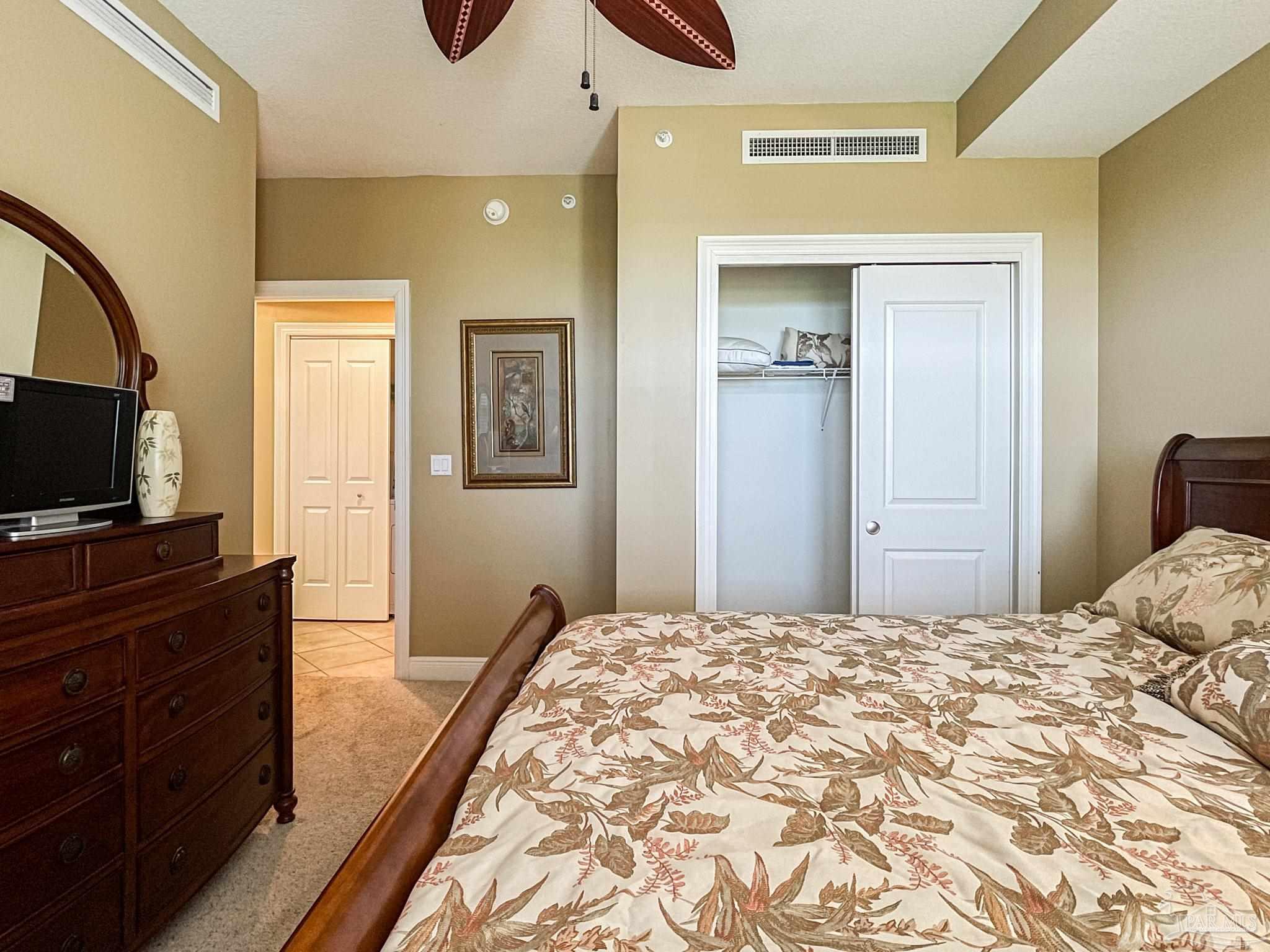 608 Lost Key Drive, Unit 604C Perdido Key, FL 32507 - Photo 20 of 38 a bedroom with a bed and a flat screen tv