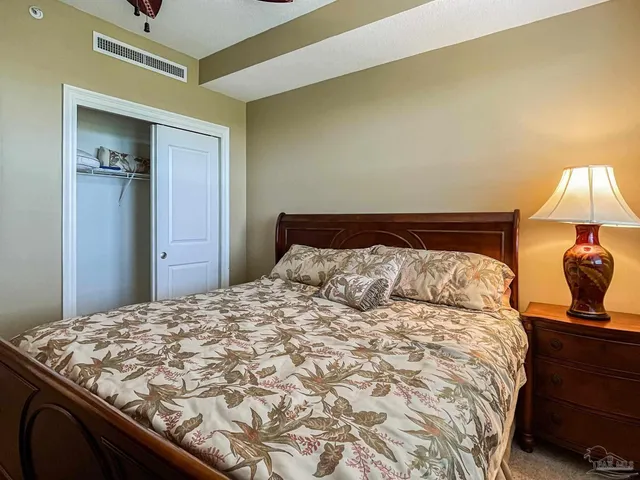 a bedroom with a bed and a lamp