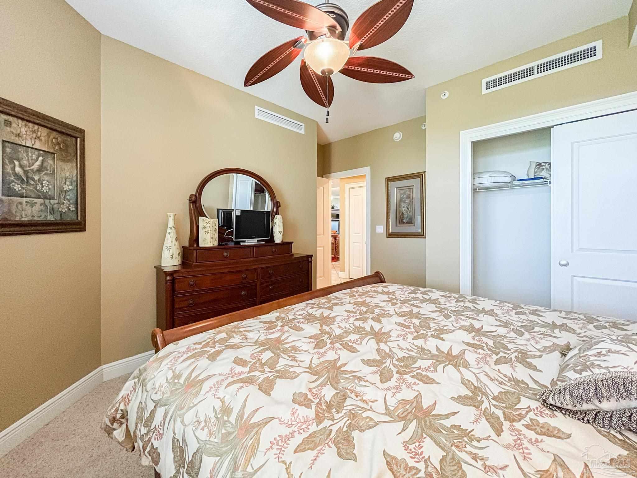 608 Lost Key Drive, Unit 604C Perdido Key, FL 32507 - Photo 22 of 38 a bedroom with a bed and a dresser