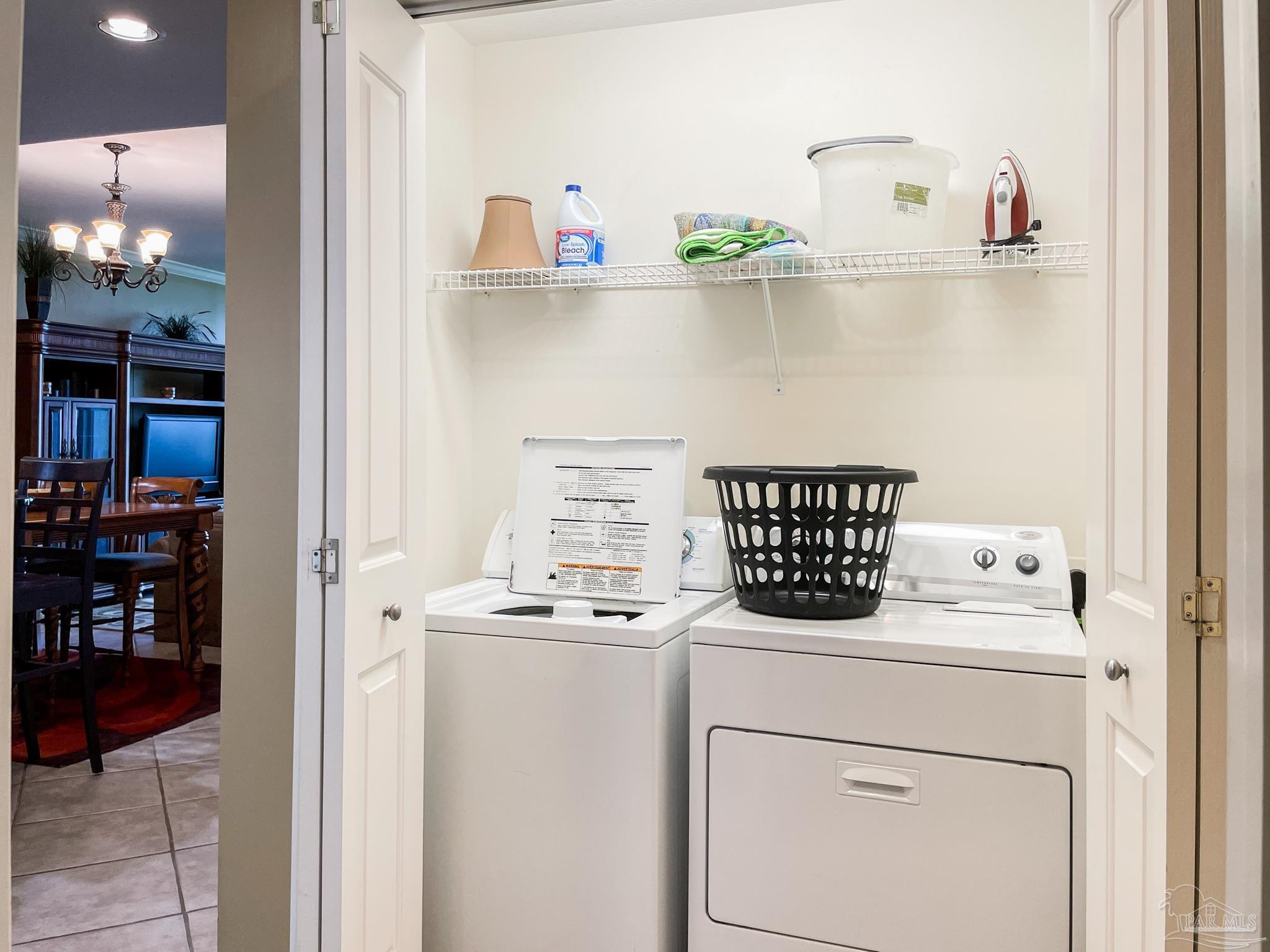 608 Lost Key Drive, Unit 604C Perdido Key, FL 32507 - Photo 23 of 38 a utility room with dryer washer and a view of kitchen