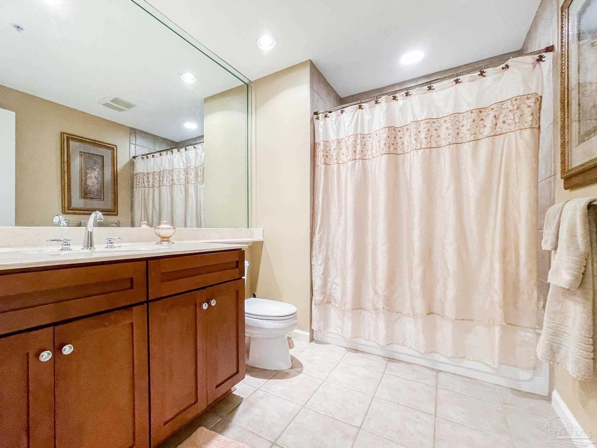 608 Lost Key Drive, Unit 604C Perdido Key, FL 32507 - Photo 24 of 38 a bathroom with a double vanity sink toilet and a mirror