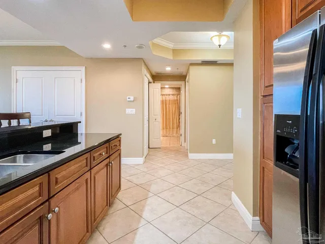 a kitchen with granite countertop a refrigerator and a sink