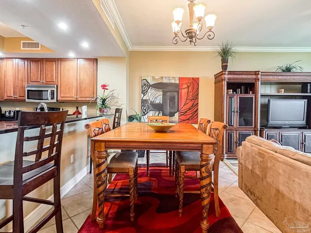 a dining room with furniture a rug and a chandelier