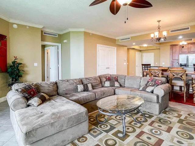 a living room with furniture and kitchen view