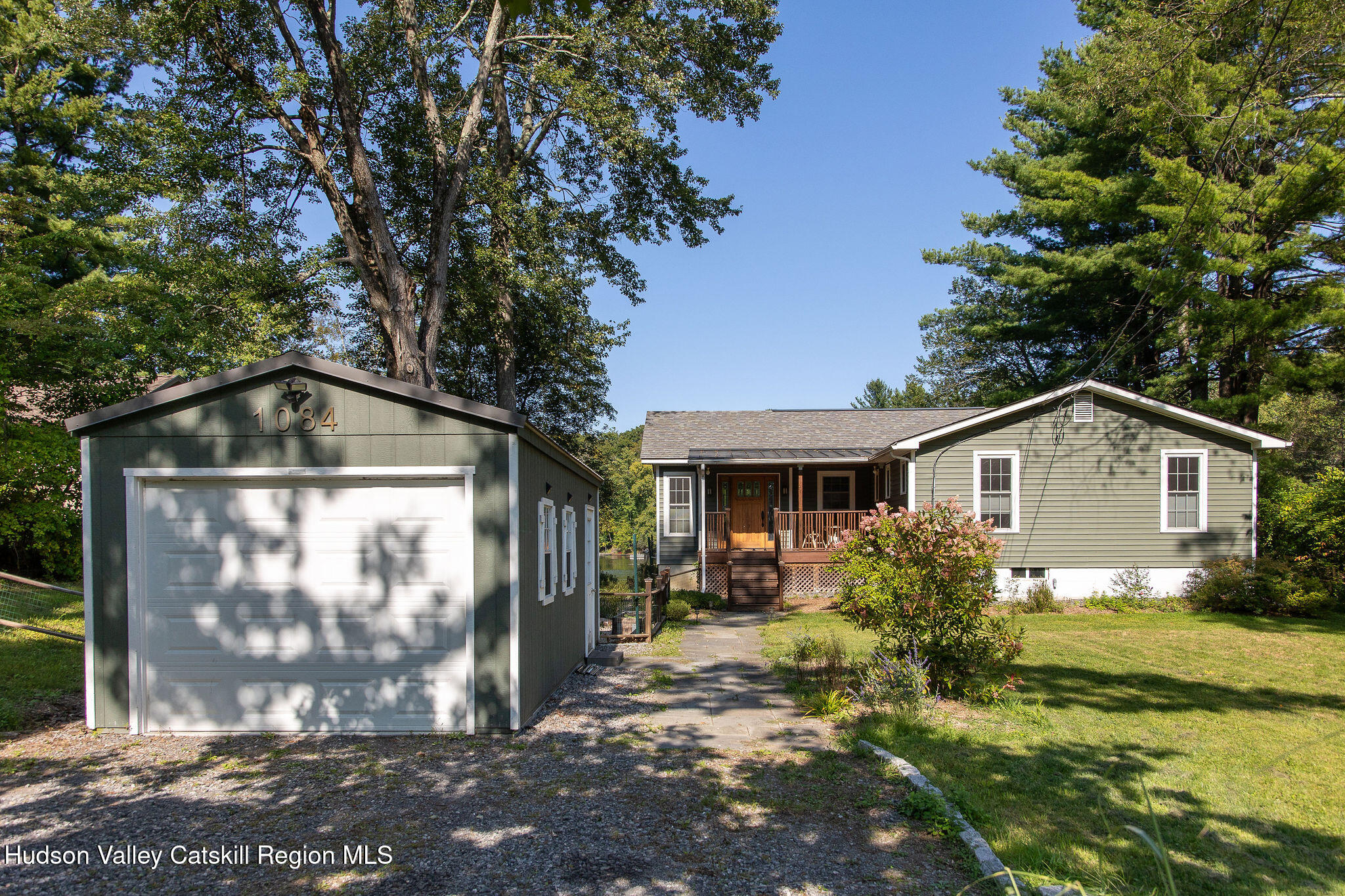 1084 Lakeview Road Copake, NY 12516 - Photo 3 of 33 a front view of a house with garden