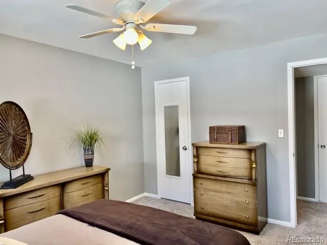 a bedroom with a bed and ceiling fan
