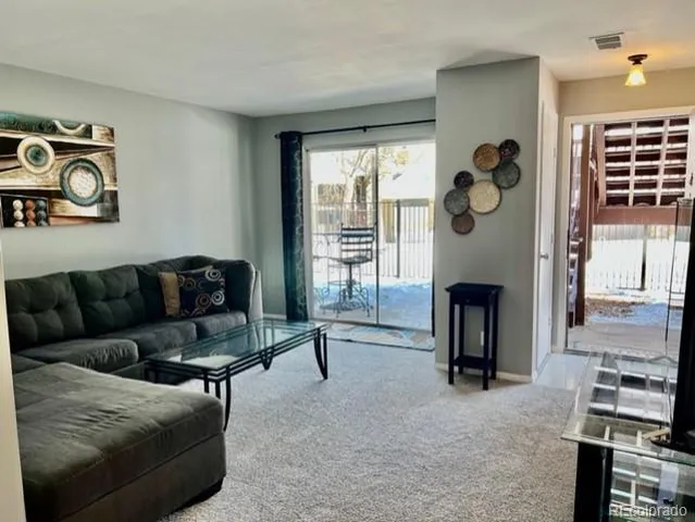a living room with furniture a window and a fireplace