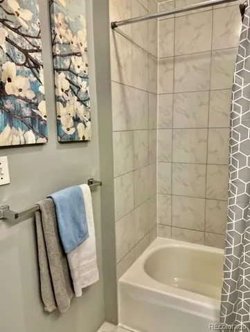 a bathroom with a bathtub and shower