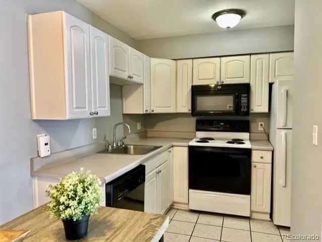 a kitchen with stainless steel appliances a stove a sink and a microwave