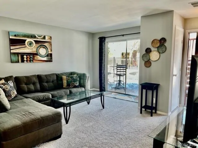 a living room with furniture and a window