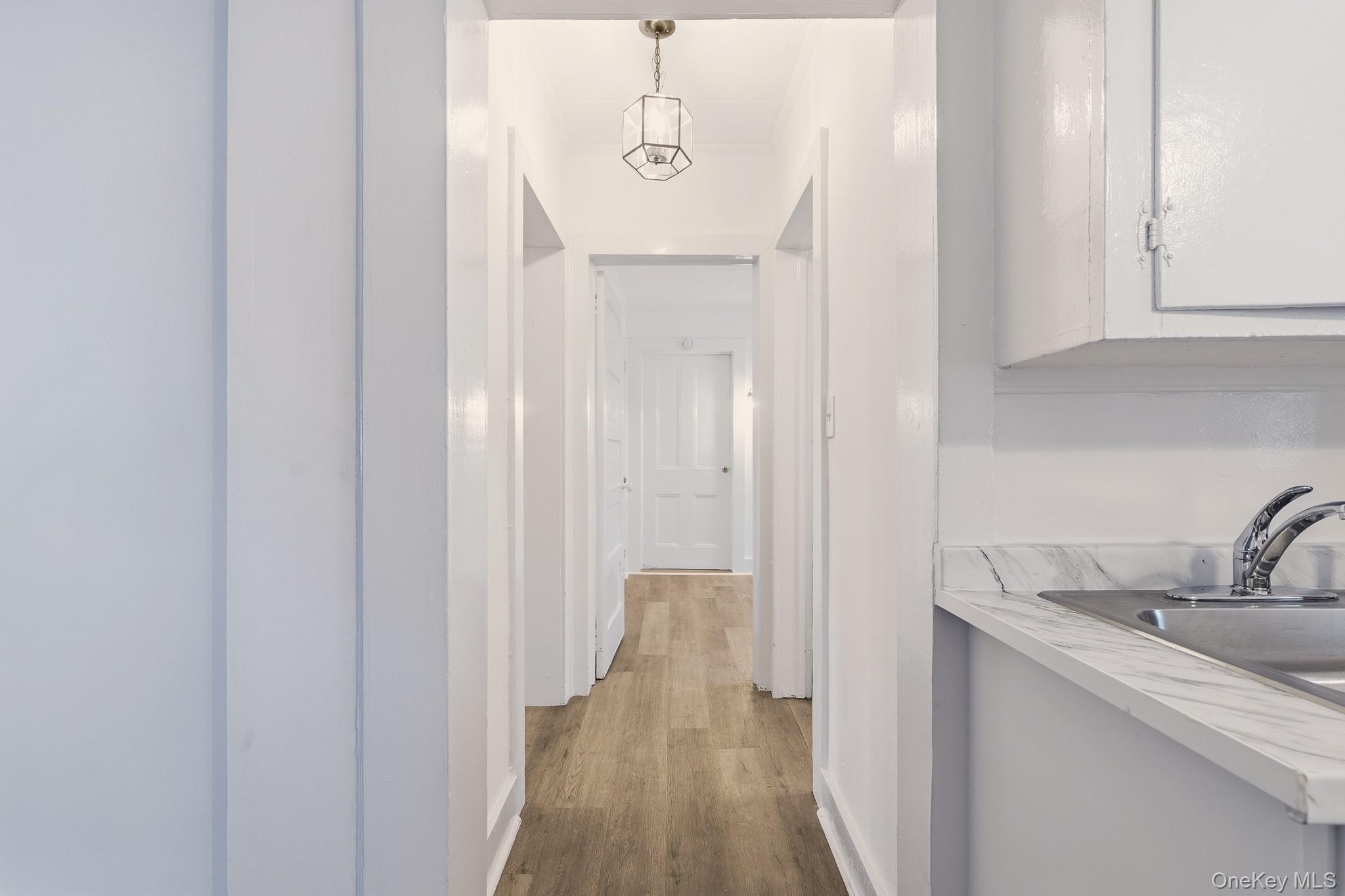 45 Gory Brook Road Sleepy Hollow, NY 10591 - Photo 14 of 18 The hallway runs through the home from front to back with beautiful wood floors and bright white paint.