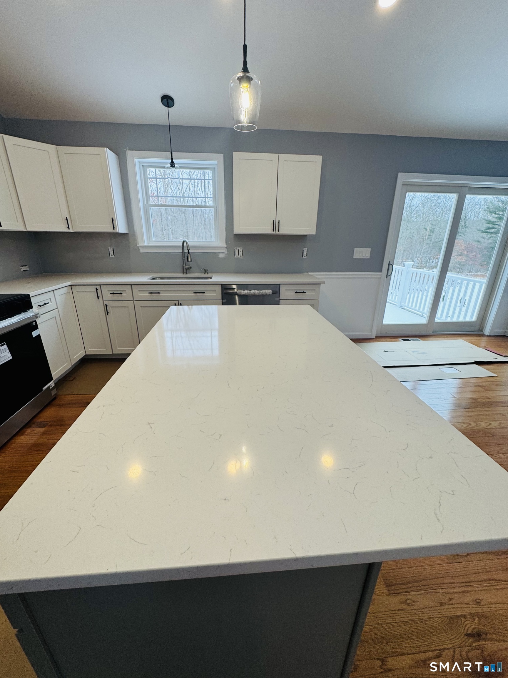 890 Brook Road Scotland, CT 06264 - Photo 13 of 23 a large white kitchen with wooden floors
