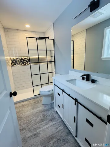 a view of a bathroom with a sink and a large mirror