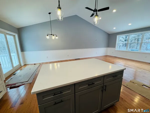 a view of kitchen with microwave and refrigerator