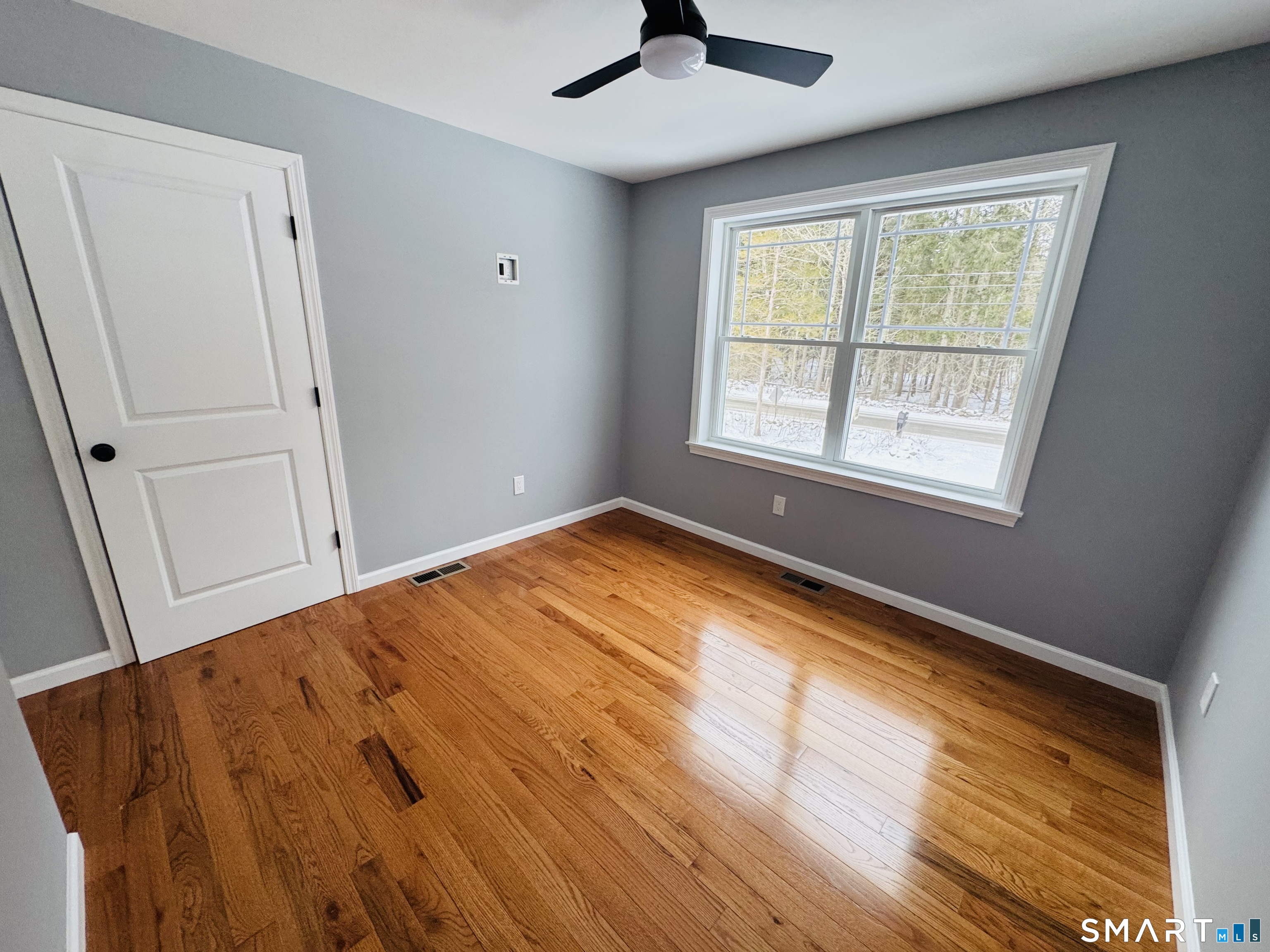 890 Brook Road Scotland, CT 06264 - Photo 7 of 23 a view of an empty room with a window and wooden floor