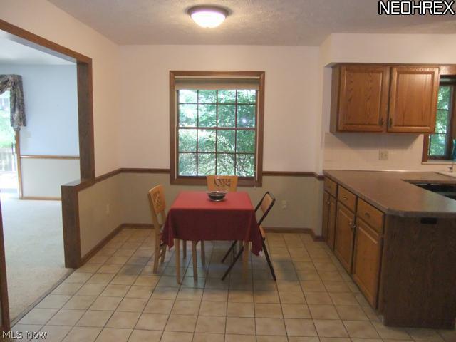 4601 Pinewood Path Akron, OH 44321 - Photo 11 of 23 The dinette is located between the kitchen and the family room and shows off tile floors.