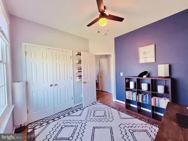 a bedroom with furniture and a book shelf