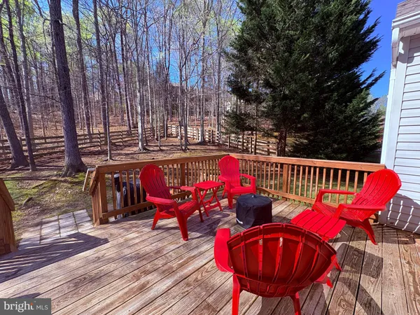 a view of balcony with wooden floor and outdoor seating