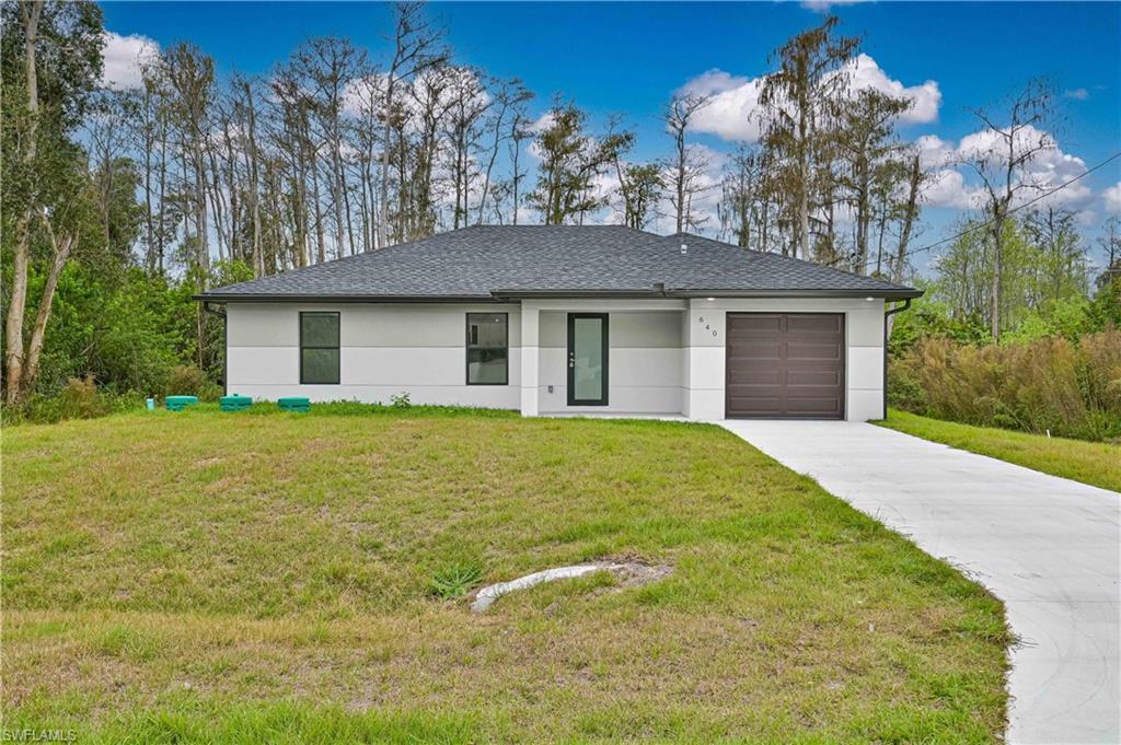 640 Lydia Street Lehigh Acres, FL 33974 - Photo 1 of 26 a house view with a garden space