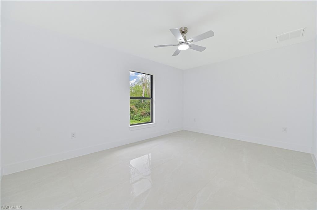 640 Lydia Street Lehigh Acres, FL 33974 - Photo 17 of 26 an empty room with a window and a fan