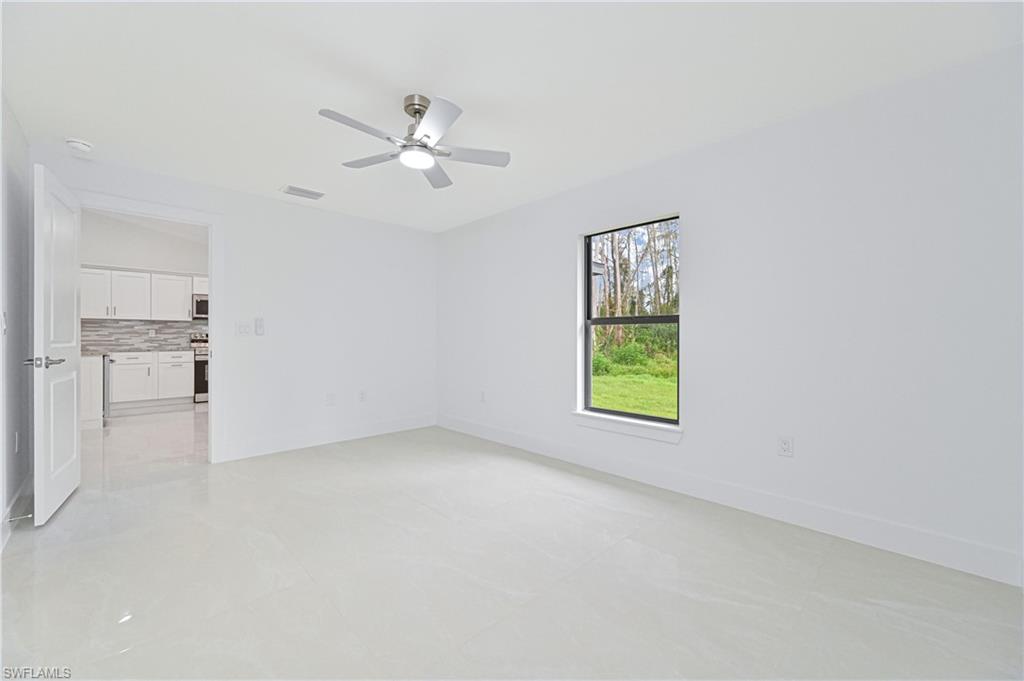 640 Lydia Street Lehigh Acres, FL 33974 - Photo 18 of 26 a view of empty room with window and ceiling fan