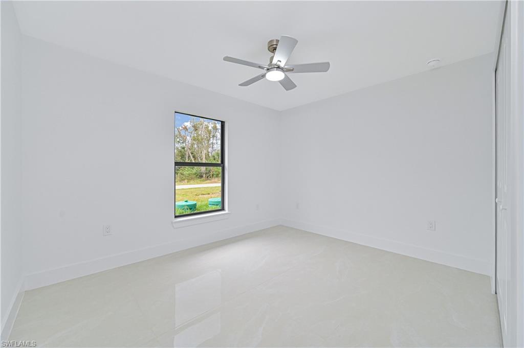 640 Lydia Street Lehigh Acres, FL 33974 - Photo 22 of 26 a view of room with window and ceiling fan
