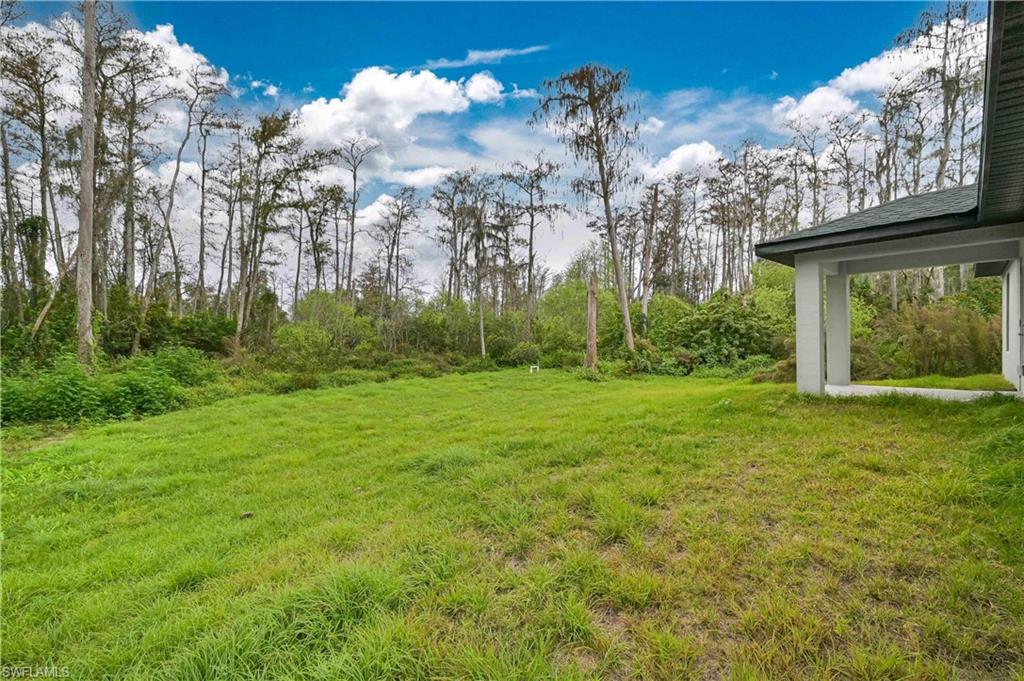 640 Lydia Street Lehigh Acres, FL 33974 - Photo 3 of 26 a view of a house with a backyard
