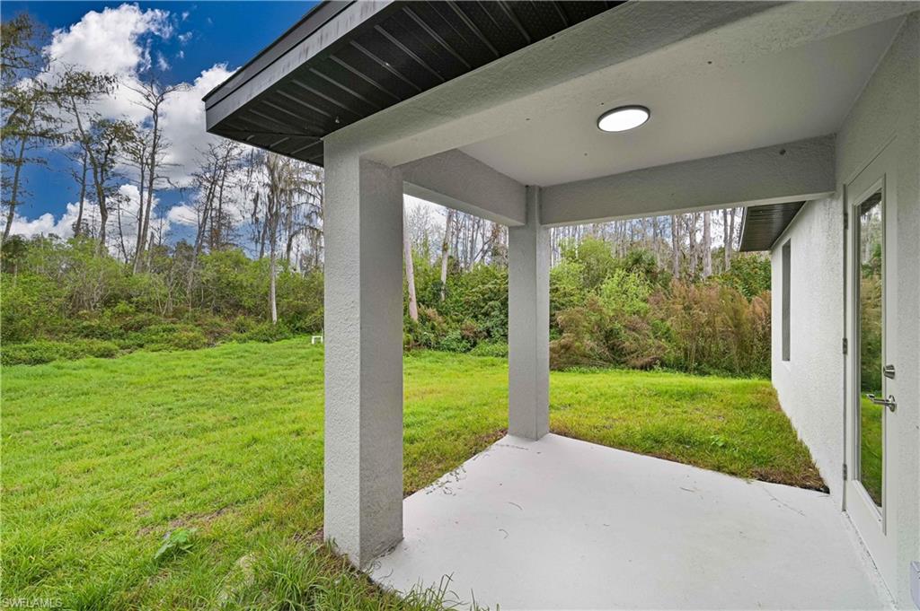 640 Lydia Street Lehigh Acres, FL 33974 - Photo 4 of 26 a view of a porch and garden