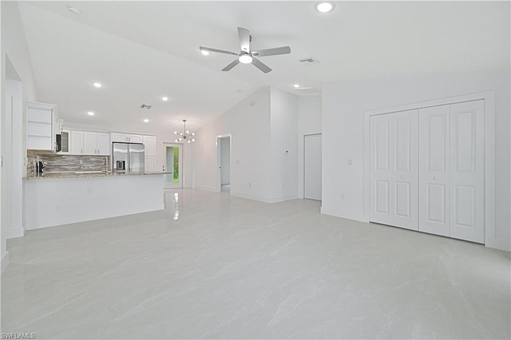 640 Lydia Street Lehigh Acres, FL 33974 - Photo 6 of 26 a view of a kitchen with a sink and a stove top oven