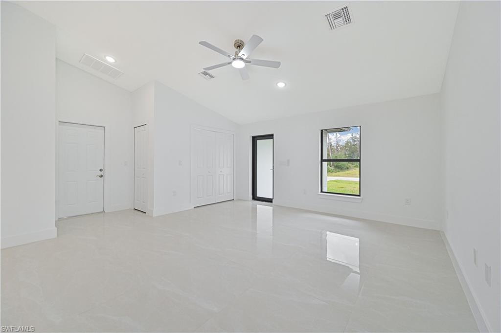 640 Lydia Street Lehigh Acres, FL 33974 - Photo 7 of 26 wooden floor in an empty room with a window