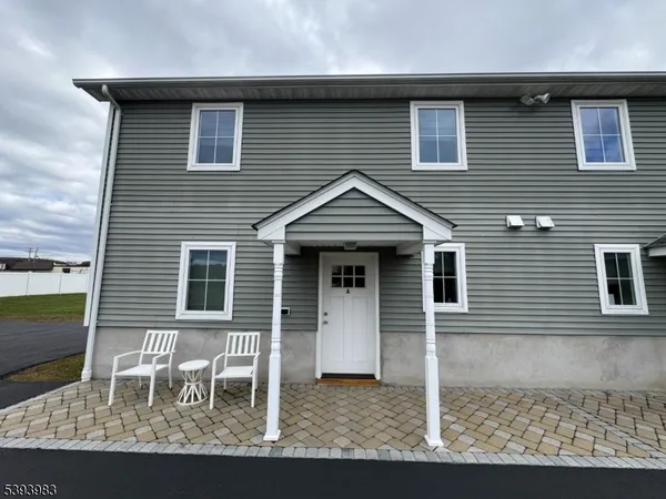 a front view of a house with table and chairs