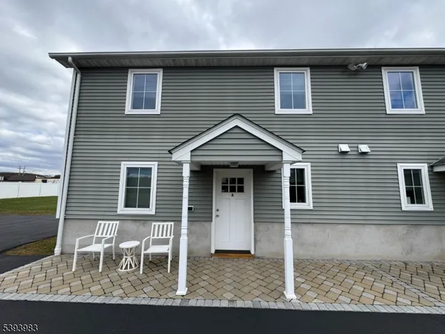 a front view of a house with table and chairs