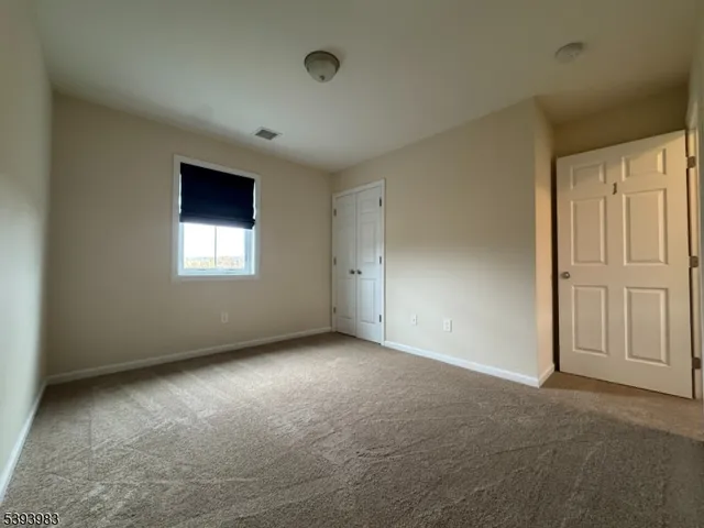 an empty room with a empty space and windows