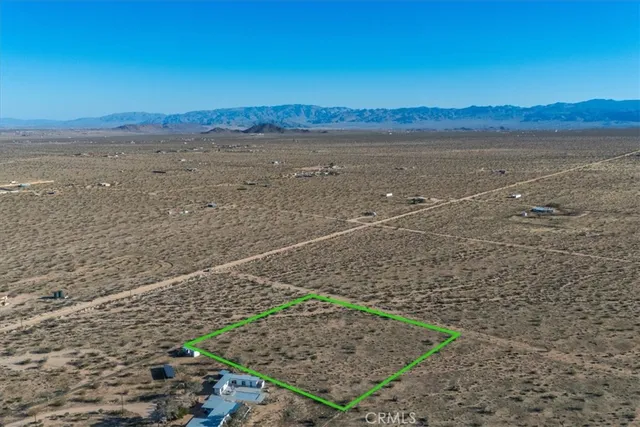 a view of an ocean beach and mountain