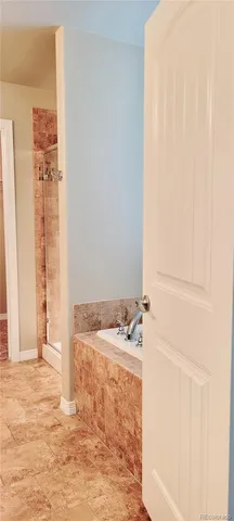 a bathroom with a tub and a sink