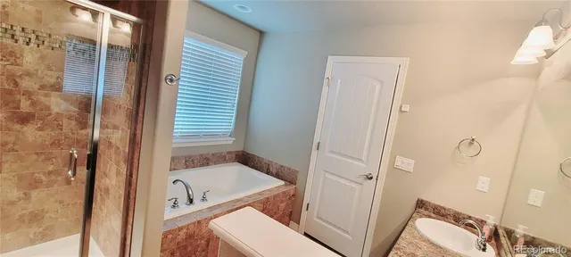 a white toilet sitting next to a shower