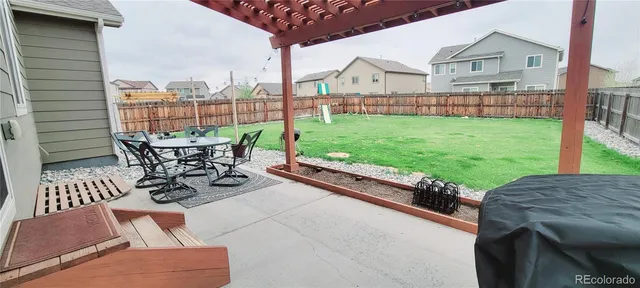a view of a patio with table and chairs and wooden floor