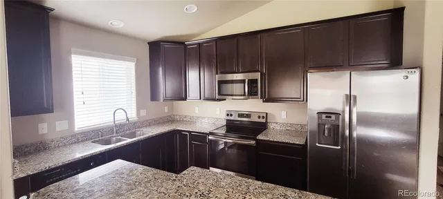 a kitchen with a refrigerator sink and microwave