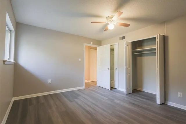 a view of an empty room with wooden floor